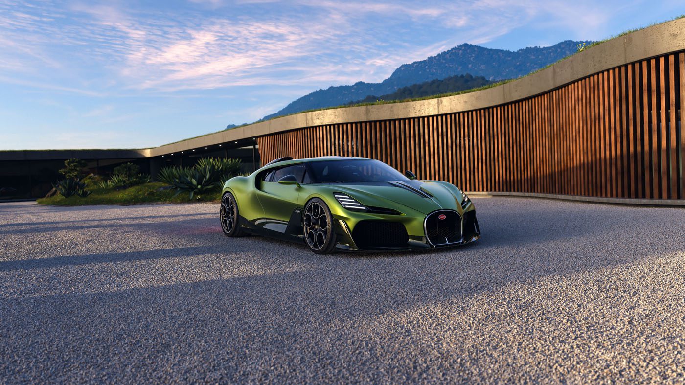 A green Bugatti sports car is parked on a gravel driveway in front of a modern wooden building with mountains in the background.