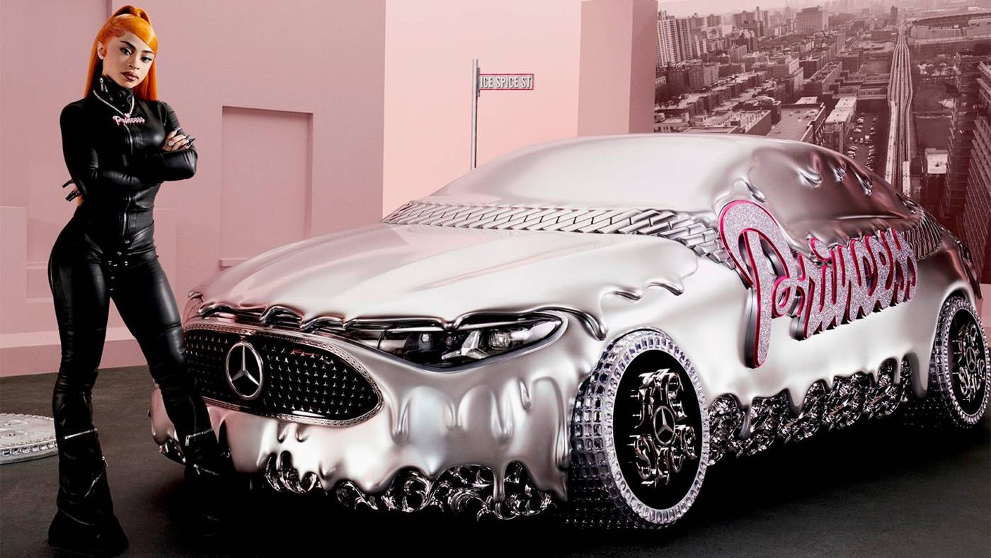 A woman in black leather stands beside a silver Mercedes-Benz CLA with "Princess" in pink on the side, set against a pink city-themed backdrop, channeling Ice Spice vibes for the ultimate remix of style and attitude.