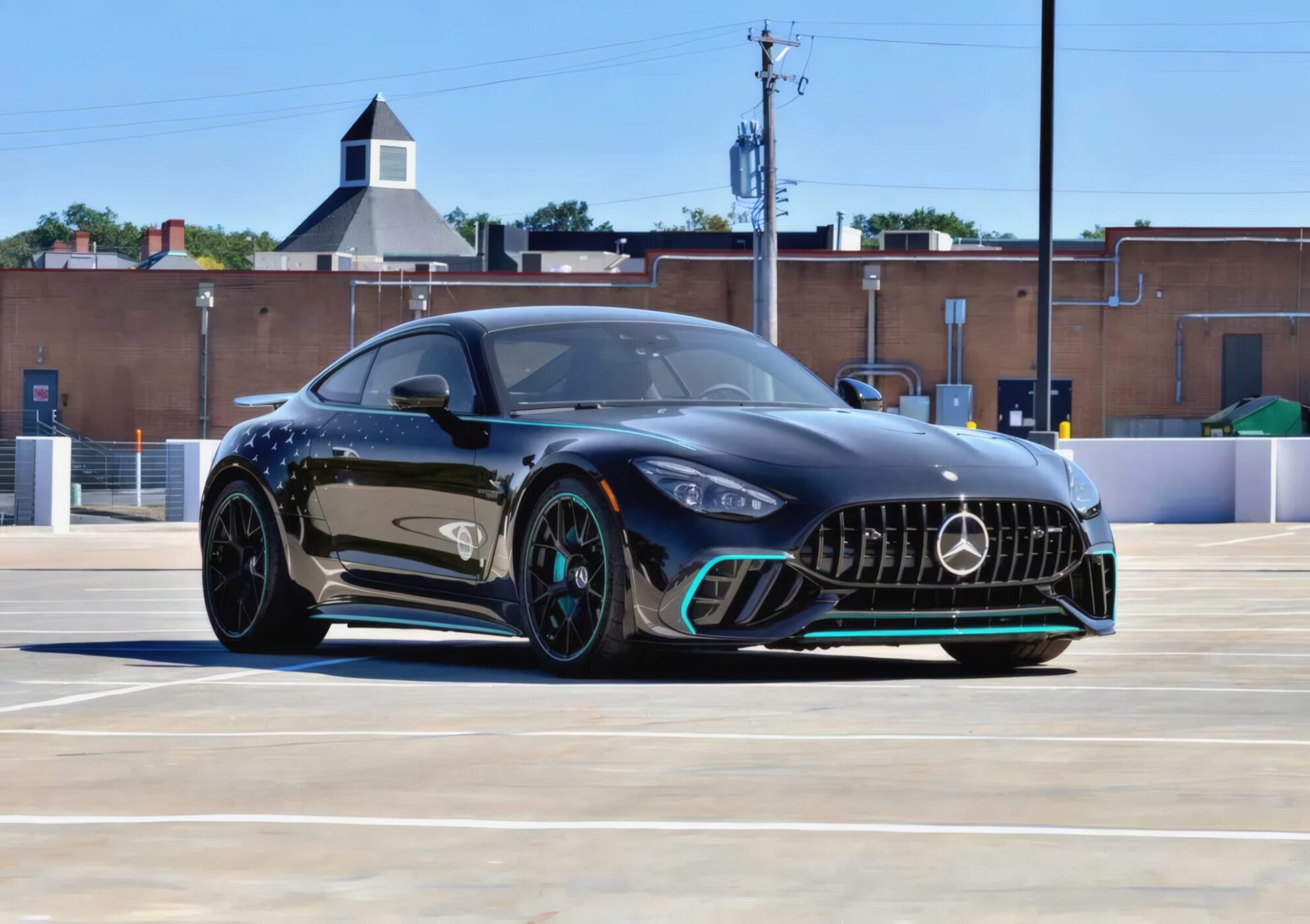 A black Mercedes-Benz AMG GT 63 PRO parked in an empty outdoor parking lot with a brick building in the background, this Collectors Edition is now available for sale.