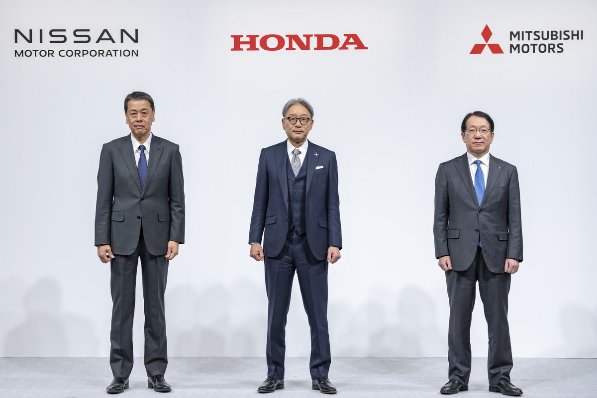 Three executives in suits stand confidently in front of the logos of renowned automakers, Nissan, Honda, and Mitsubishi Motors, displayed against a pristine white background.