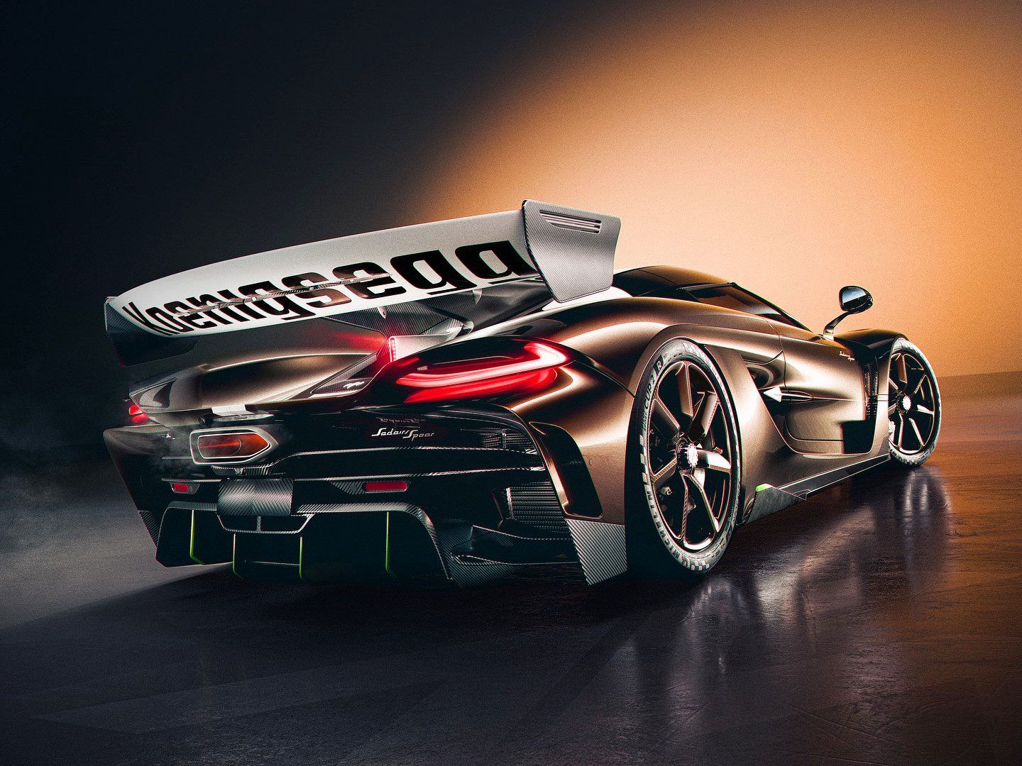 A sleek black hypercar with a large rear wing is shown under dramatic lighting, highlighting its aerodynamic design and sporty features—Farewell Jesko, enter the Spear.