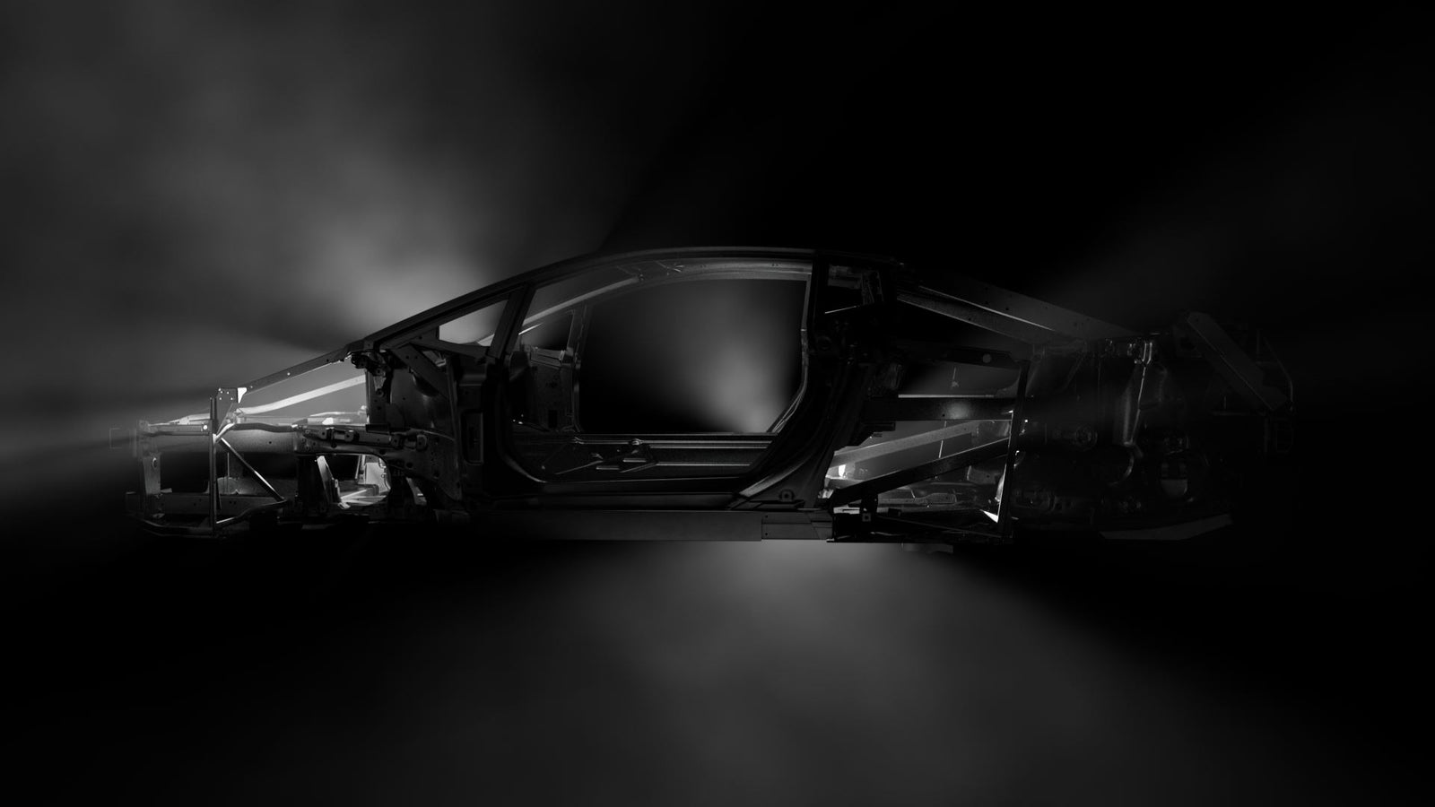 Side view of a Temerario car frame in dark lighting, highlighting its lightweight spaceframe structure and contours.