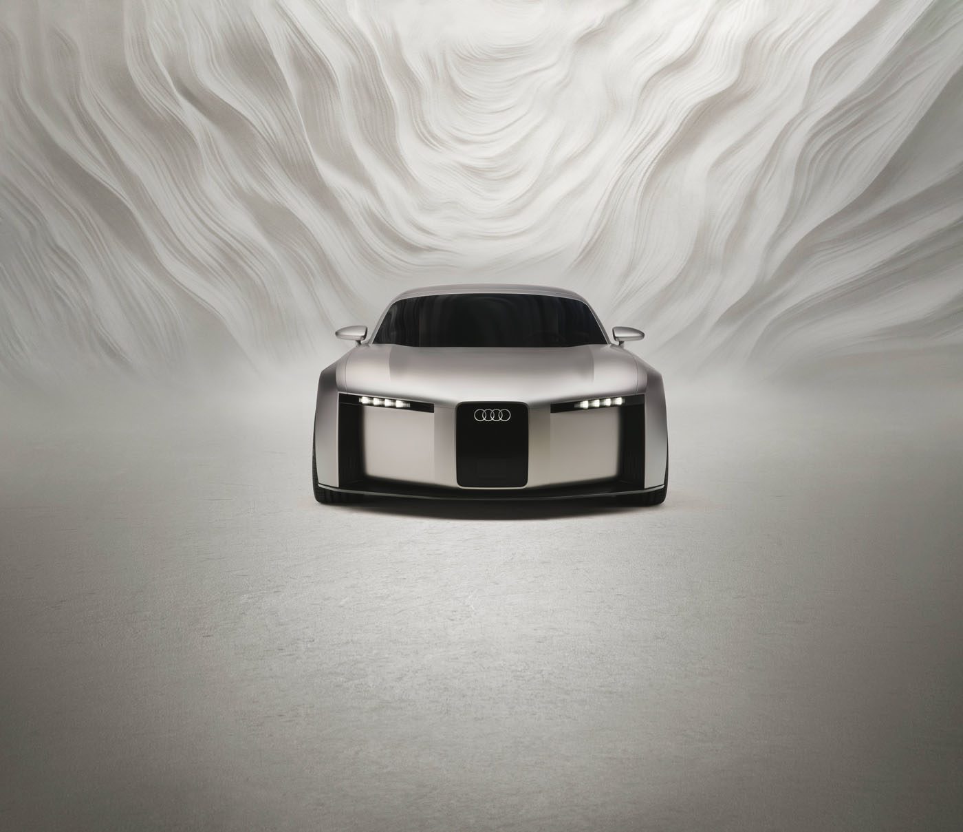 A silver Audi concept sports car is shown from the front in a minimalistic, white setting with abstract, wavy wall patterns in the background.