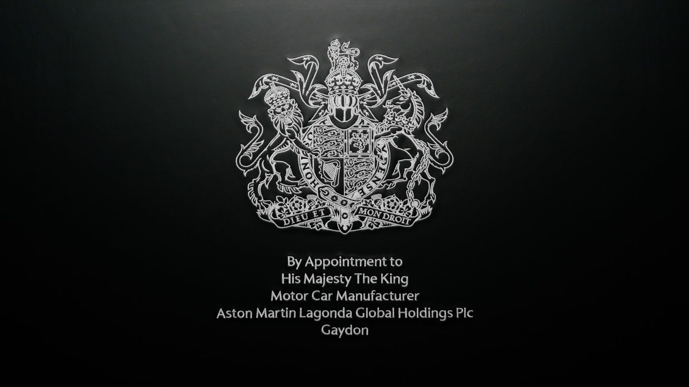 Aston Martin proudly begins using the prestigious Royal Warrant, officially appointed by His Majesty The King as an esteemed motor car manufacturer, symbolized by the iconic royal coat of arms.