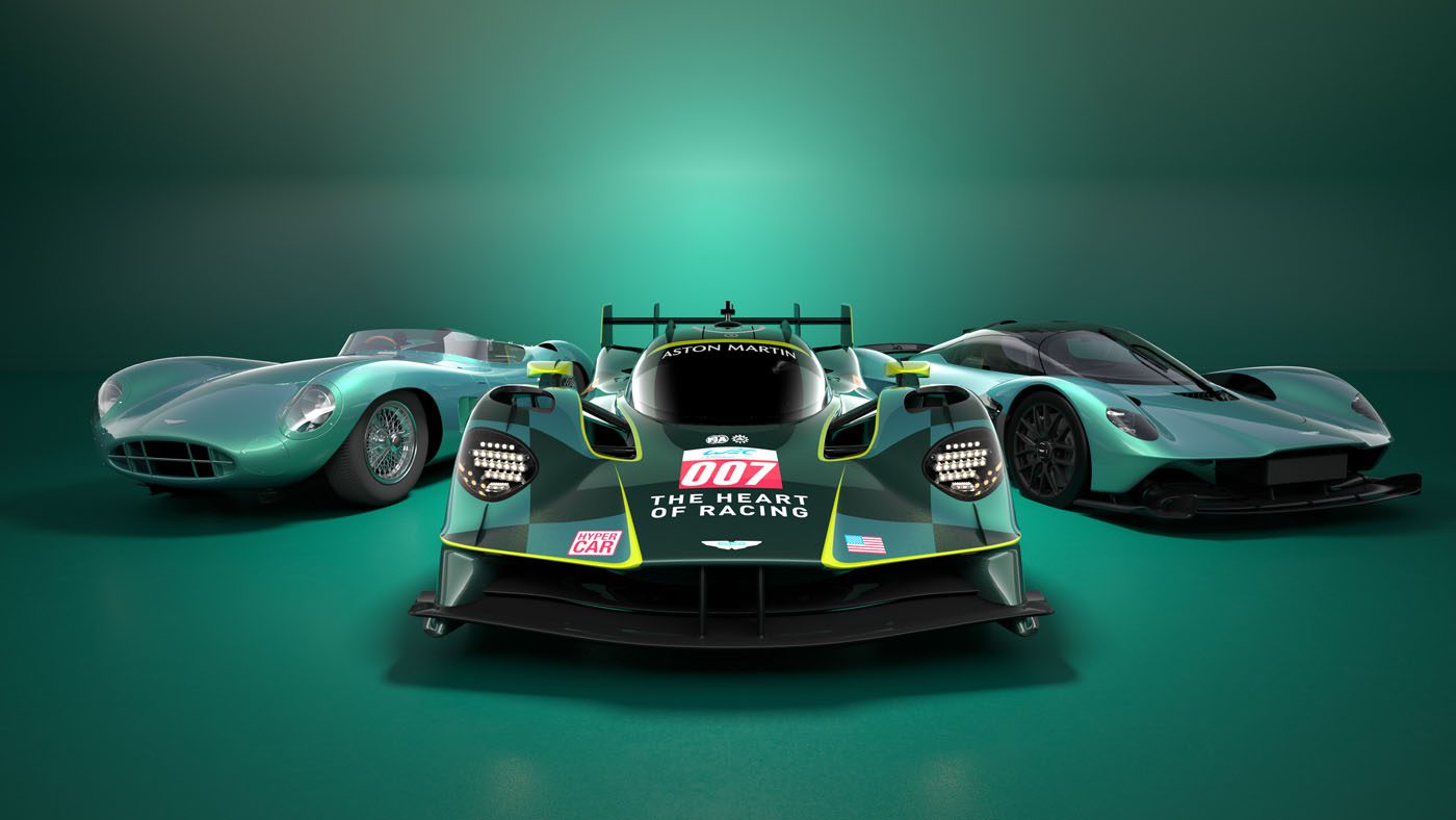 Three green Aston Martin cars, including a sleek Valkyrie Hypercar, are displayed in a row. The center car proudly features "007" and "The Heart of Racing" emblazoned on it.