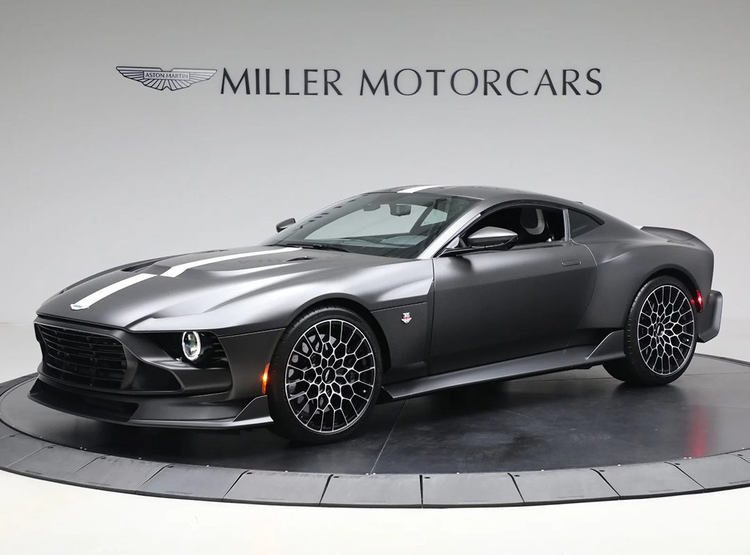 A 2024 Aston Martin Valour in Xenon Grey Metallic is displayed in a showroom with "Miller Motorcars" branding on the wall behind it.