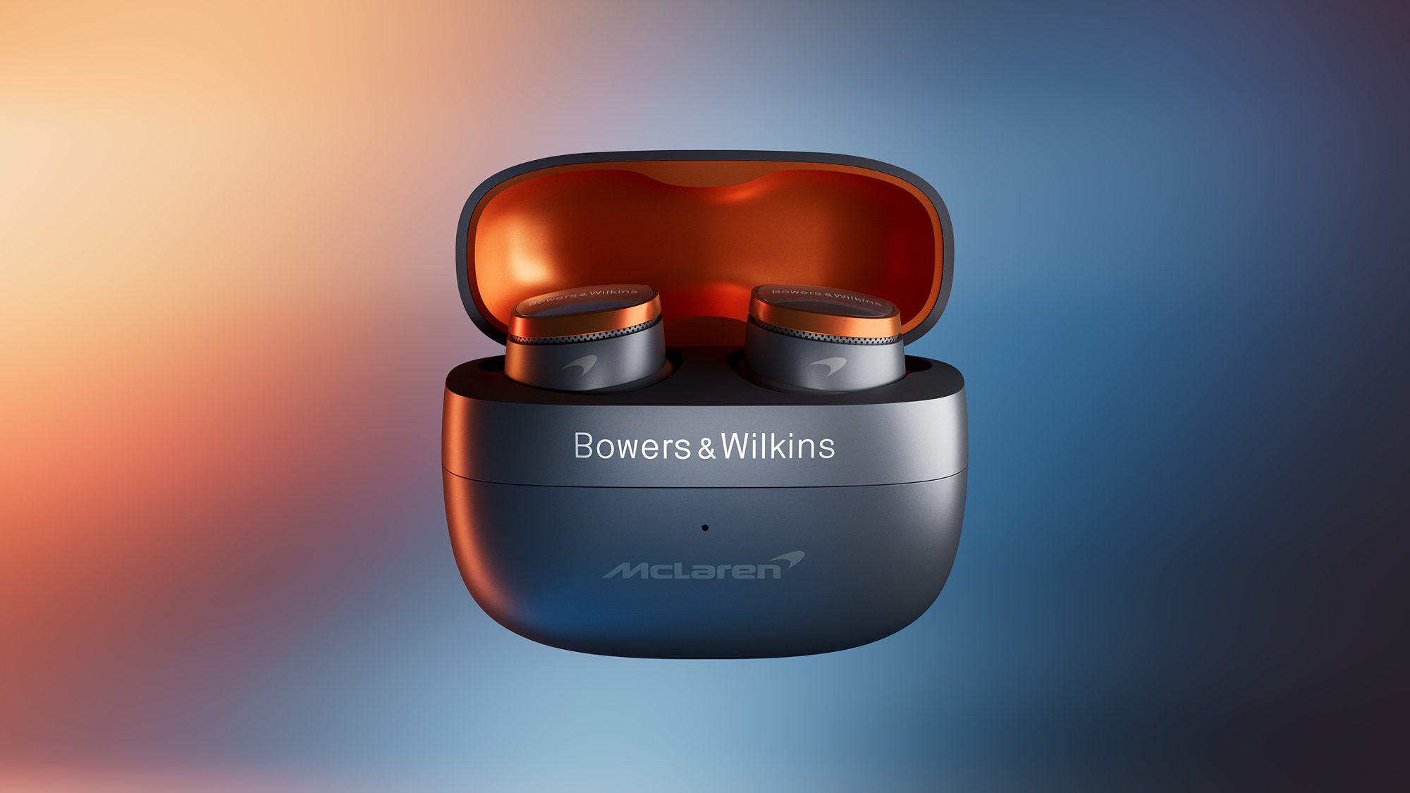 Bowers & Wilkins earbuds in a black and orange case with McLaren branding, set against a gradient background.
