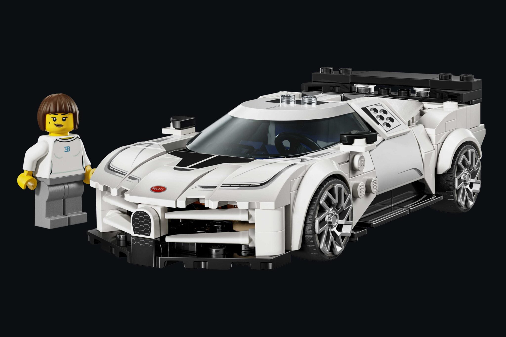 A white LEGO sports car with black details is displayed on a black background, accompanied by a LEGO figure in white. LEGO and Bugatti unite to celebrate the iconic Centodieci, bringing this legendary car to brick-built life.