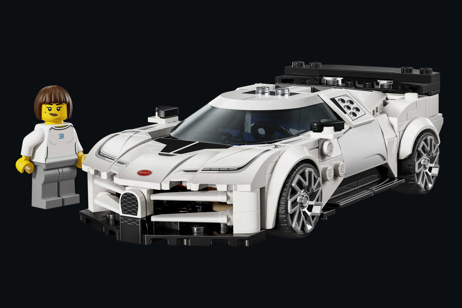 A white LEGO sports car with black details is displayed on a black background, accompanied by a LEGO figure in white. LEGO and Bugatti unite to celebrate the iconic Centodieci, bringing this legendary car to brick-built life.