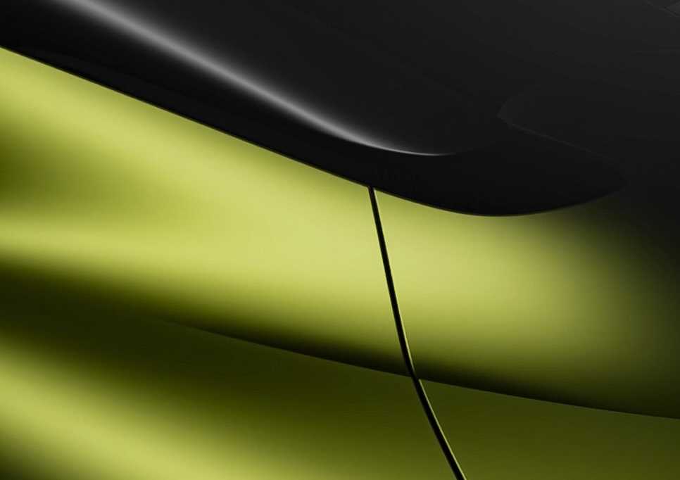 Close-up view of a Bugatti's exterior, showcasing smooth green and black surfaces with a sharp panel line—hinting at the remarkable details of this one-off supercar ahead of its August 7 reveal.