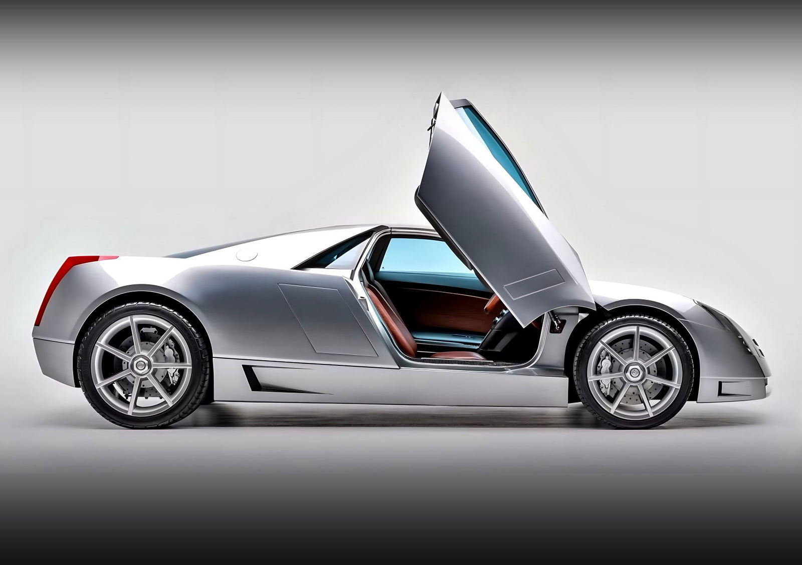 A silver sports car with gull-wing doors open, shown in a side profile against a neutral background—reminiscent of the 10 unsung mid-engine American concepts that pushed the envelope of performance.