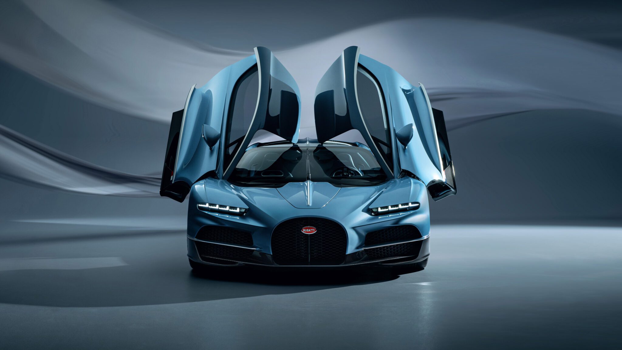 The Bugatti sports car, envisioned by Director of Design Frank Heyll, features striking blue hues and open butterfly doors, showcased against a blurred, abstract background.