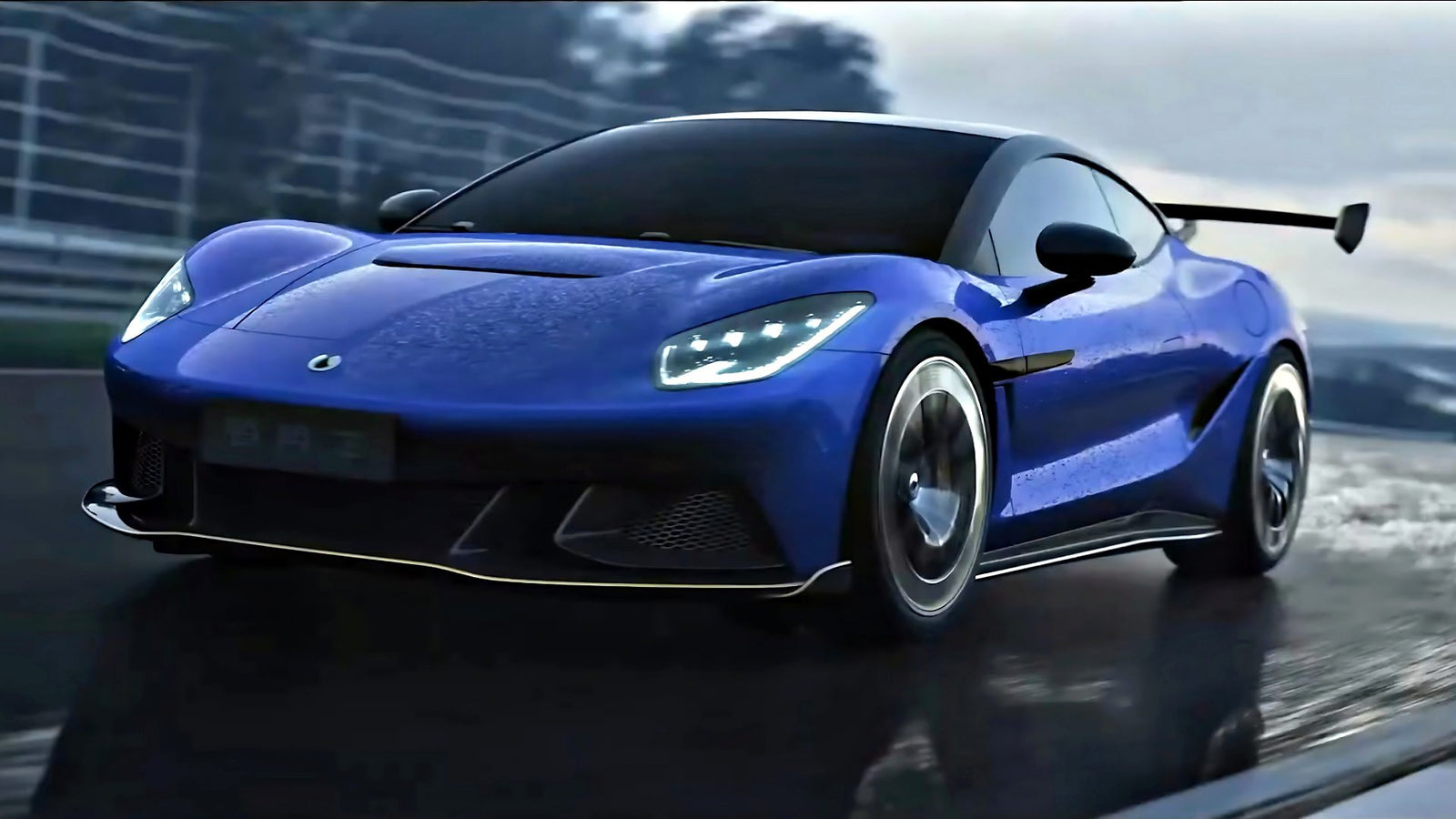 A blue Denza Z sportscar with 952 HP and headlights on drives on a wet racetrack, its reflection shimmering on the damp surface, surrounded by blurred fencing and trees.