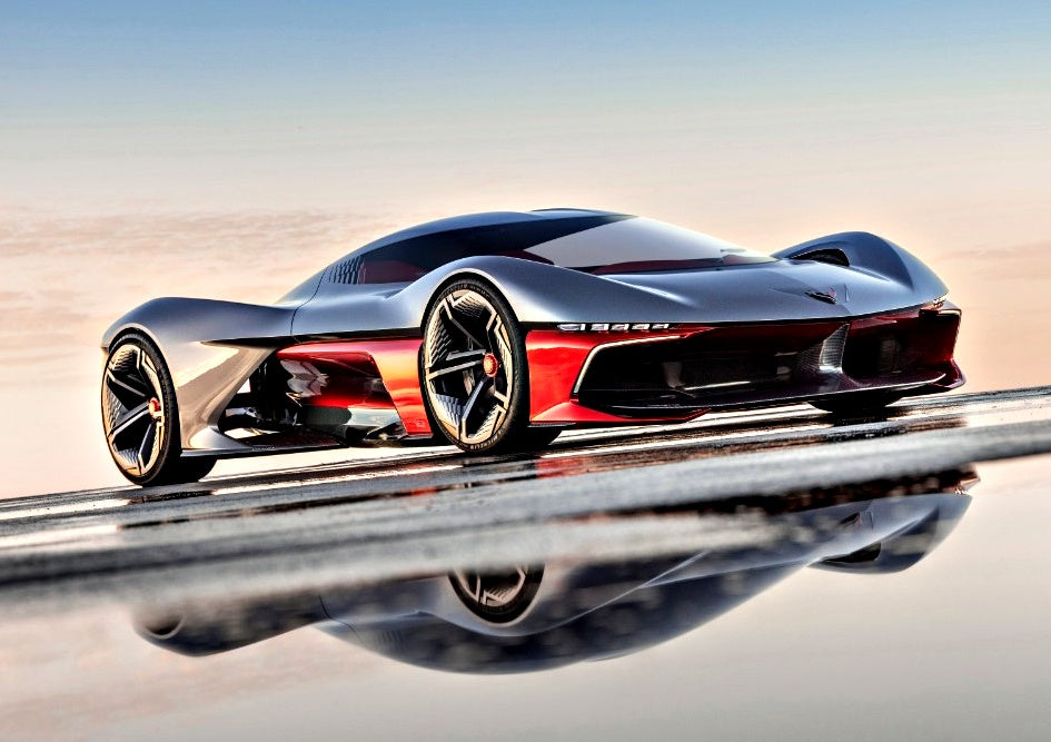 A sleek, futuristic red and black sports car with aerodynamic design is parked on a reflective surface under a clear sky—reminiscent of the California Corvette: GM's Pasadena Studio showcases this stunning one-off hypercar concept.