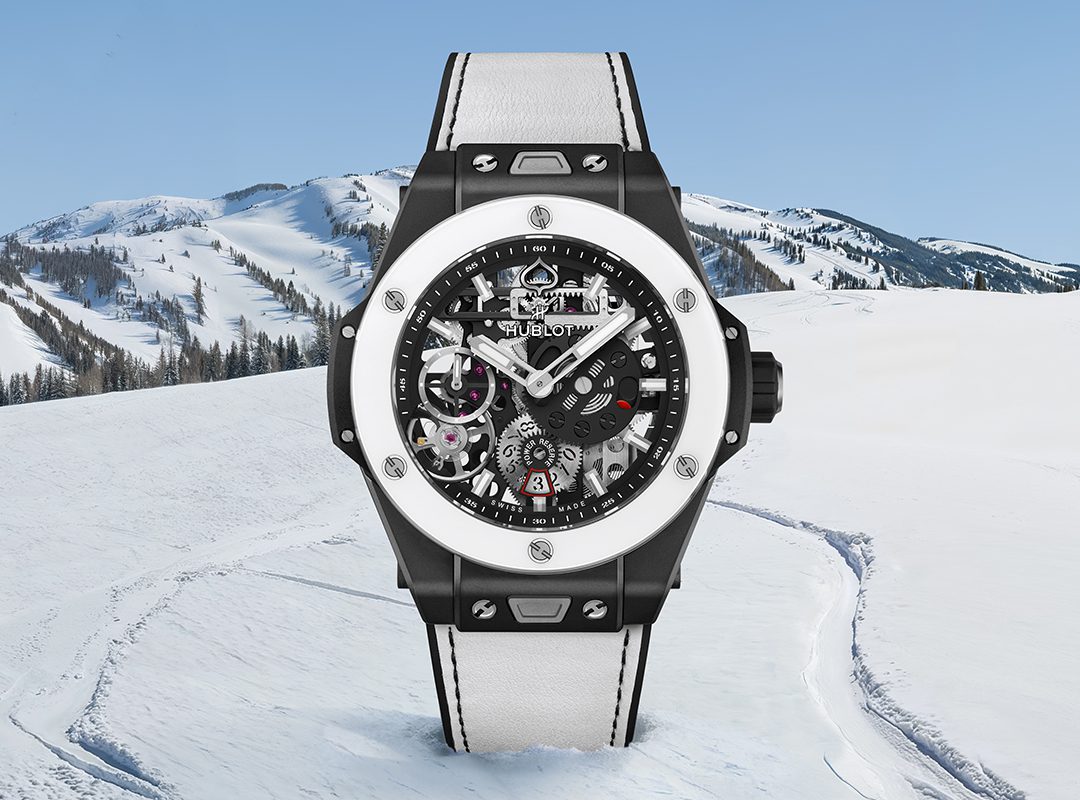 Set against a snowy mountain landscape, the Hublot Big Bang MECA-10 wristwatch boasts a mechanical, skeletonized dial complemented by a sleek black and white strap, embodying true mountain luxury.