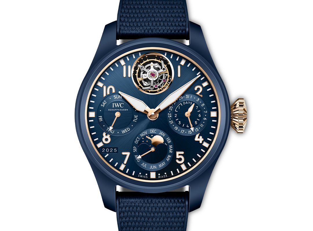 A blue IWC Schaffhausen wristwatch with gold accents showcasing the time, day, date, month, year, power reserve, and a striking tourbillon at 12 o’clock—a perfect blend of luxury and precision from the Tourbillon Pilot's Watches collection.