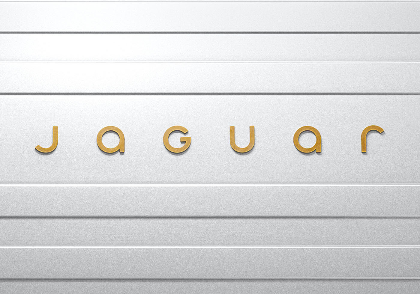 The image showcases the Jaguar logo, with the word "jaguar" elegantly rendered in gold letters on a textured silver-gray surface, embodying the brand identity's sleek sophistication.