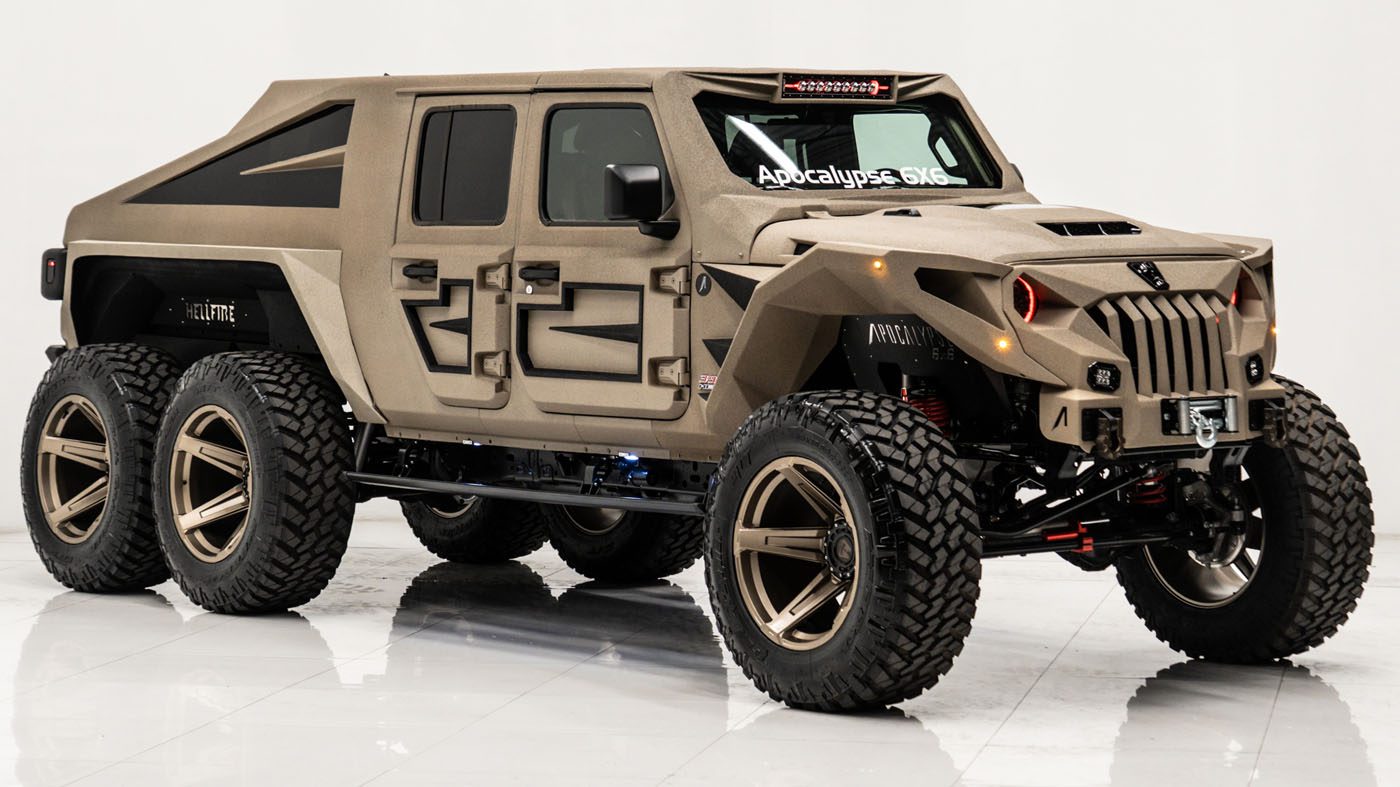 A custom-built, matte tan six-wheeled off-road truck by Apocalypse Manufacturing with large tires, angular body design, and aggressive front grille, displayed in a well-lit studio—perfect for survival trucks enthusiasts.