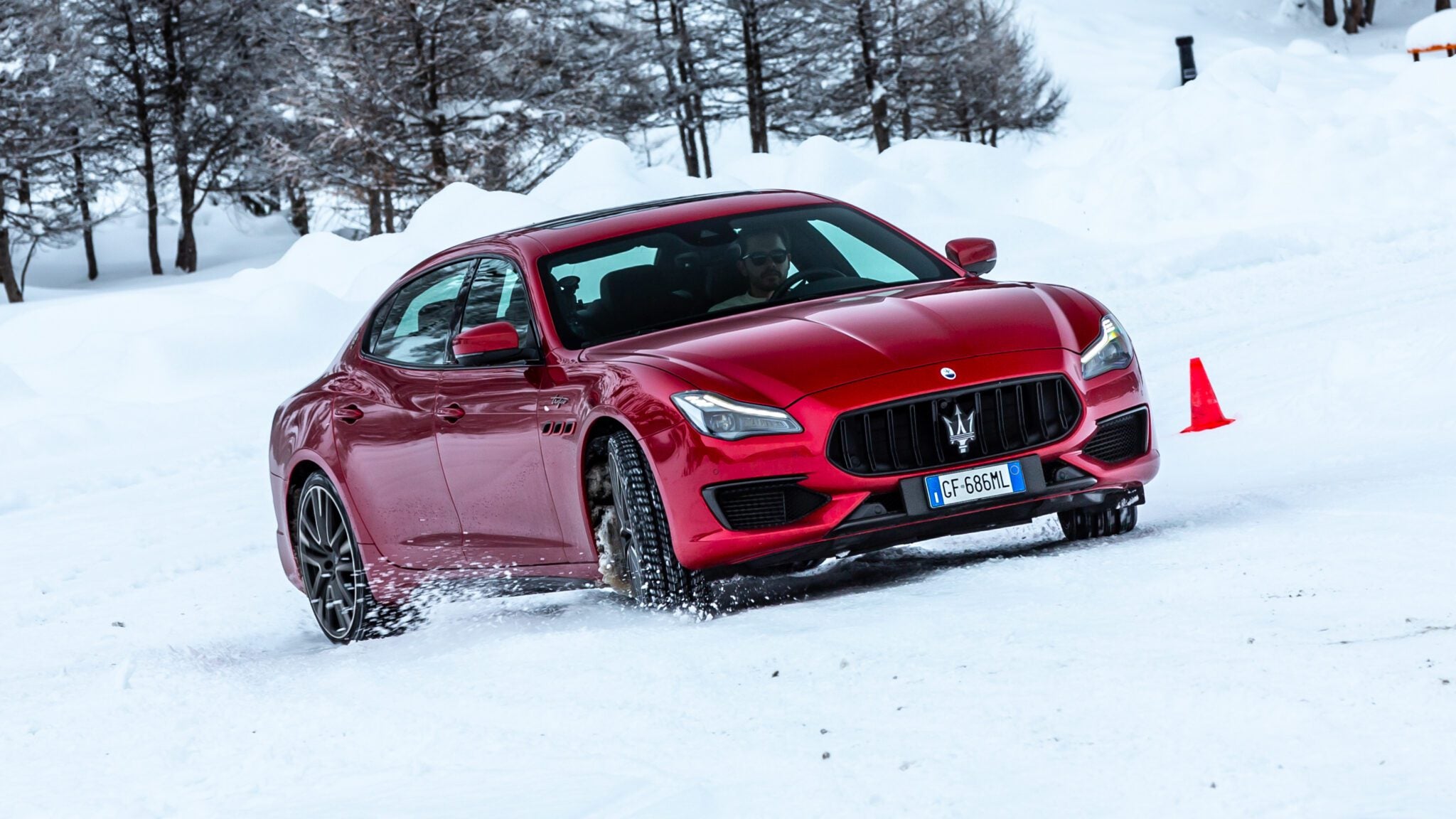 An image of a Maserati Quattroporte Trofeo sedan sliding in the snow.