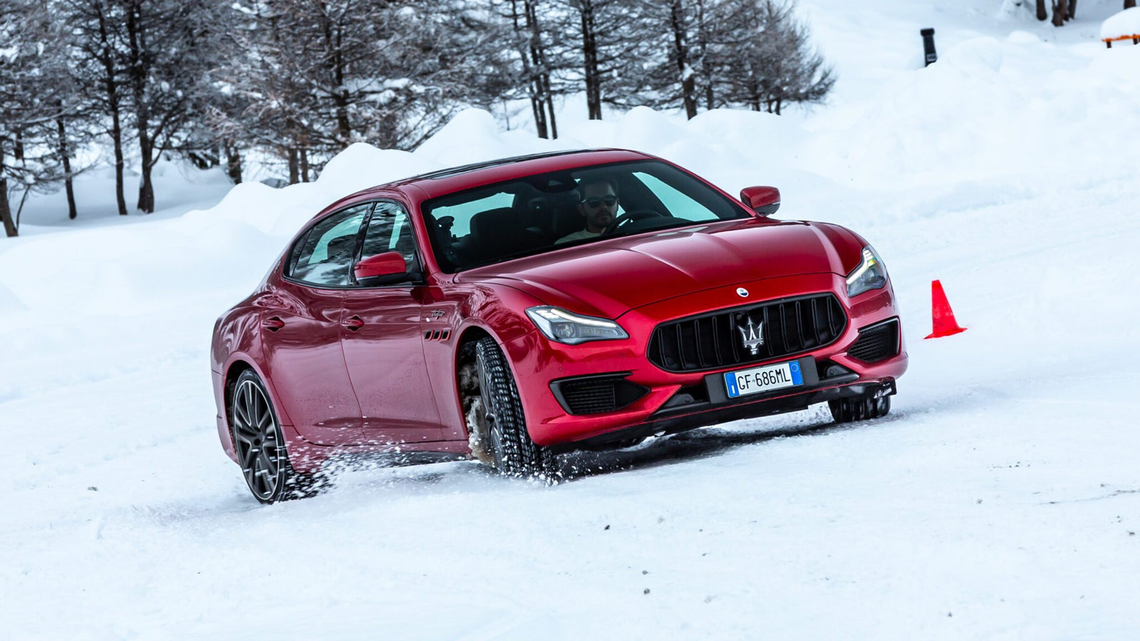 An image of a Maserati Quattroporte Trofeo sedan sliding in the snow.