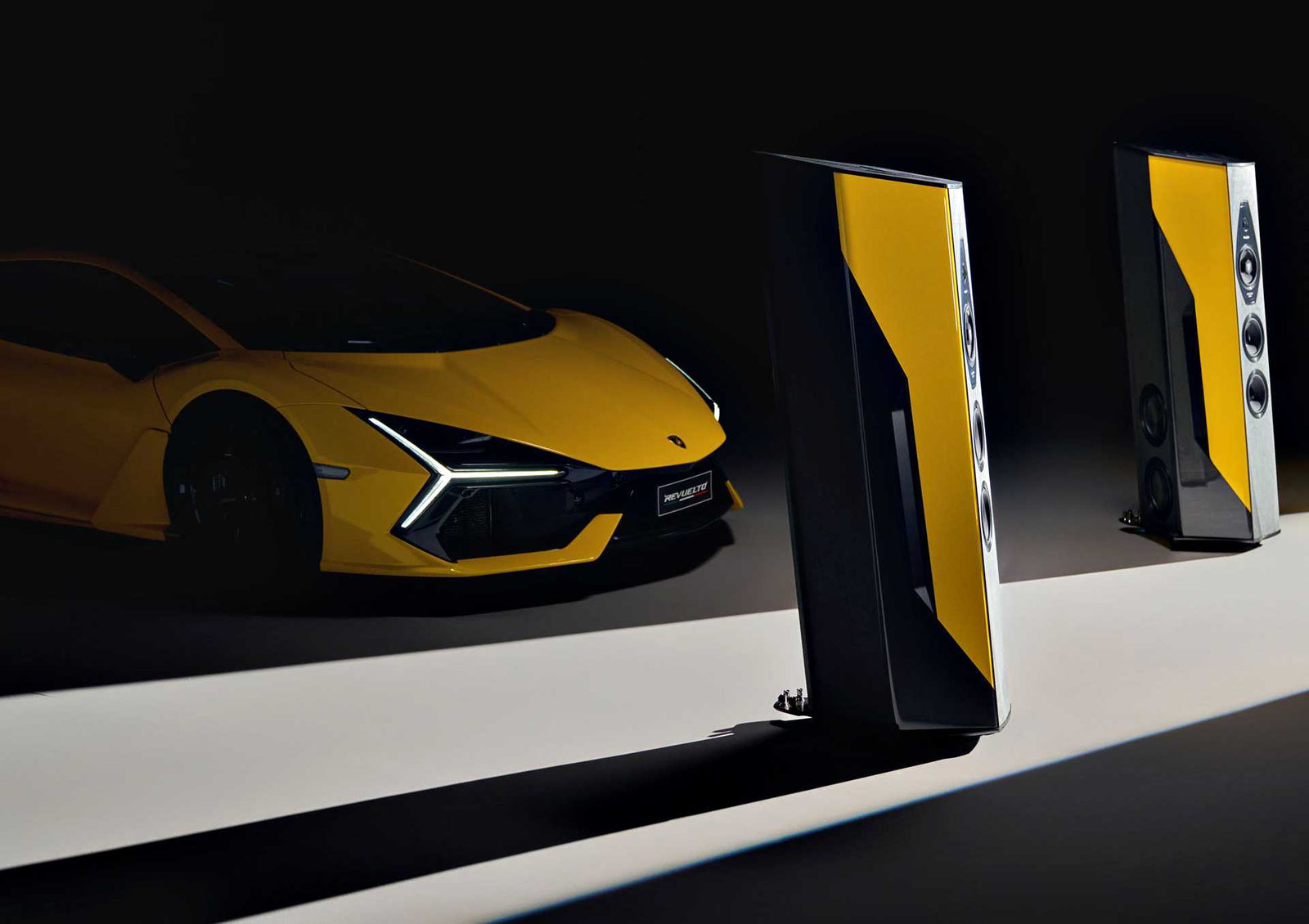 A yellow sports car stands next to a speaker—Only 50 Worldwide: Lamborghini x Sonus Faber Il Cremonese Ex3me set to make its Monterey debut.