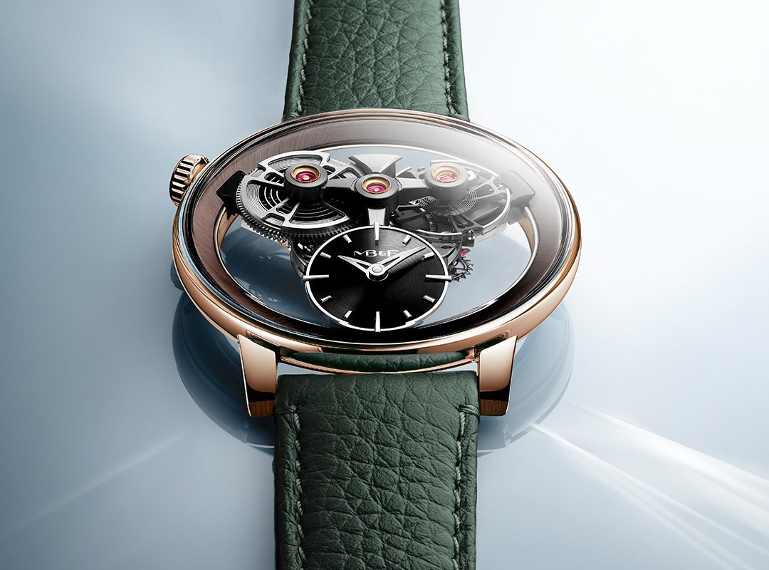 A luxury SP One Watch from the Special Projects Collection, featuring a green leather strap, rose gold case, and exposed mechanical gears displayed on a light blue reflective surface.