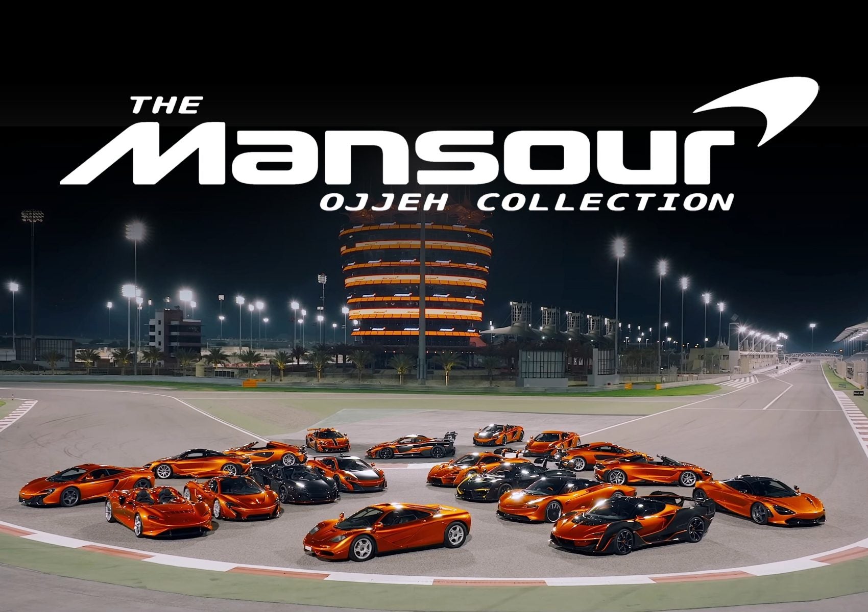 A group of ultra-exclusive McLarens parked in formation on a racetrack at night, with a lit circular building and "The Mansour Ojjeh Collection" text above.