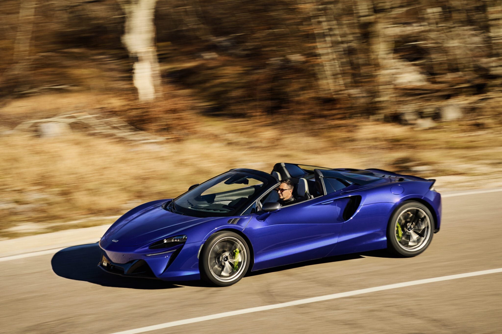 An image of a McLaren Artura Spider on the road.