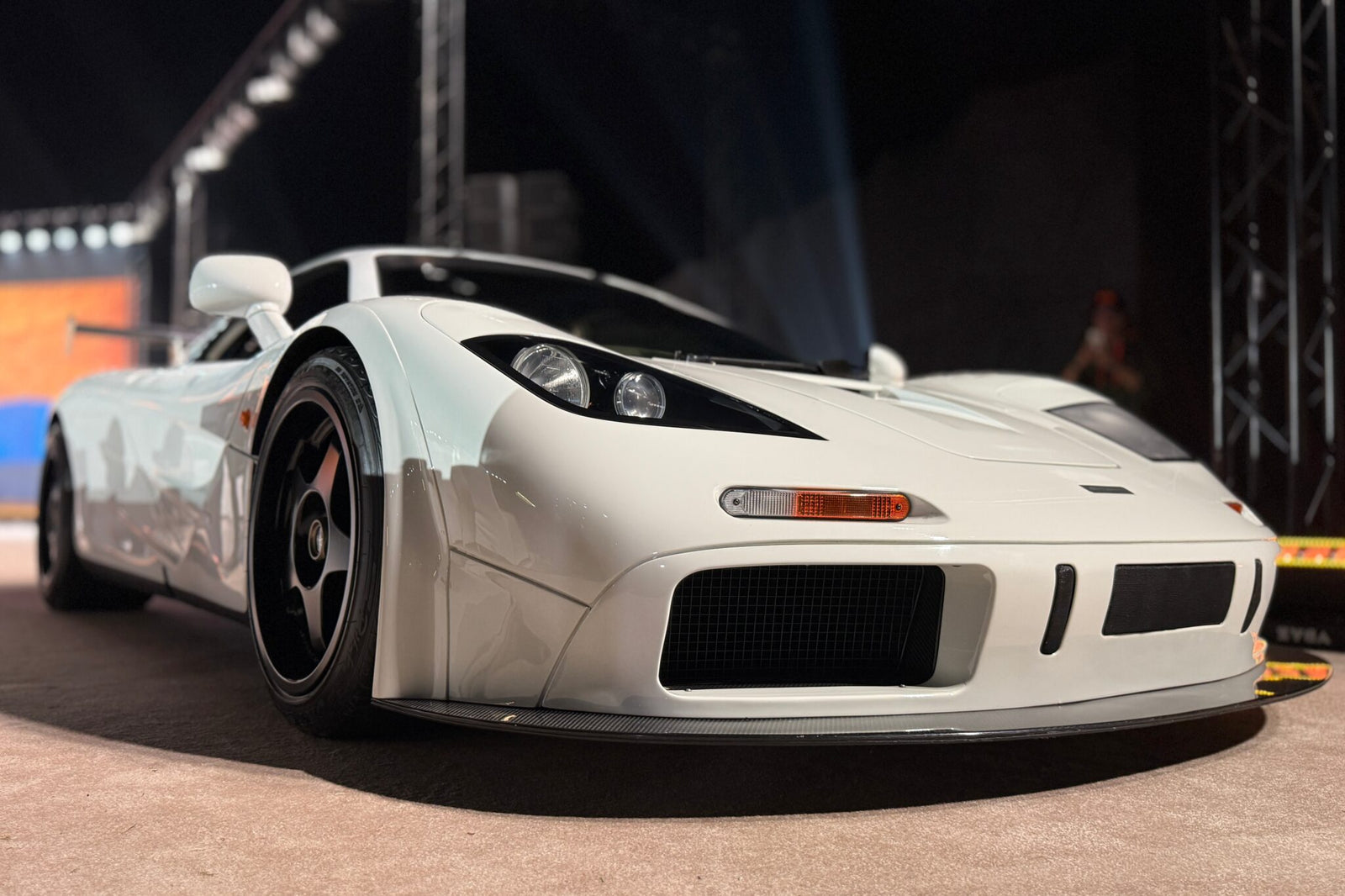A white sports car with black wheels displayed indoors under bright lights, photographed from a low front angle—Feature Exclusive: $25.3M McLaren F1 leads RM Sotheby's Abu Dhabi Auction.