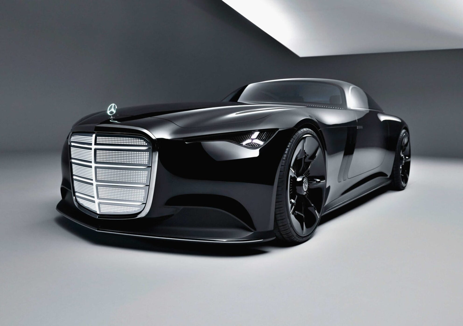 A sleek, black Mercedes-Benz luxury concept car with a prominent grille and low profile, the Vision Iconic is displayed in a modern, minimalistic showroom, embodying the elegance of the Electric Era.