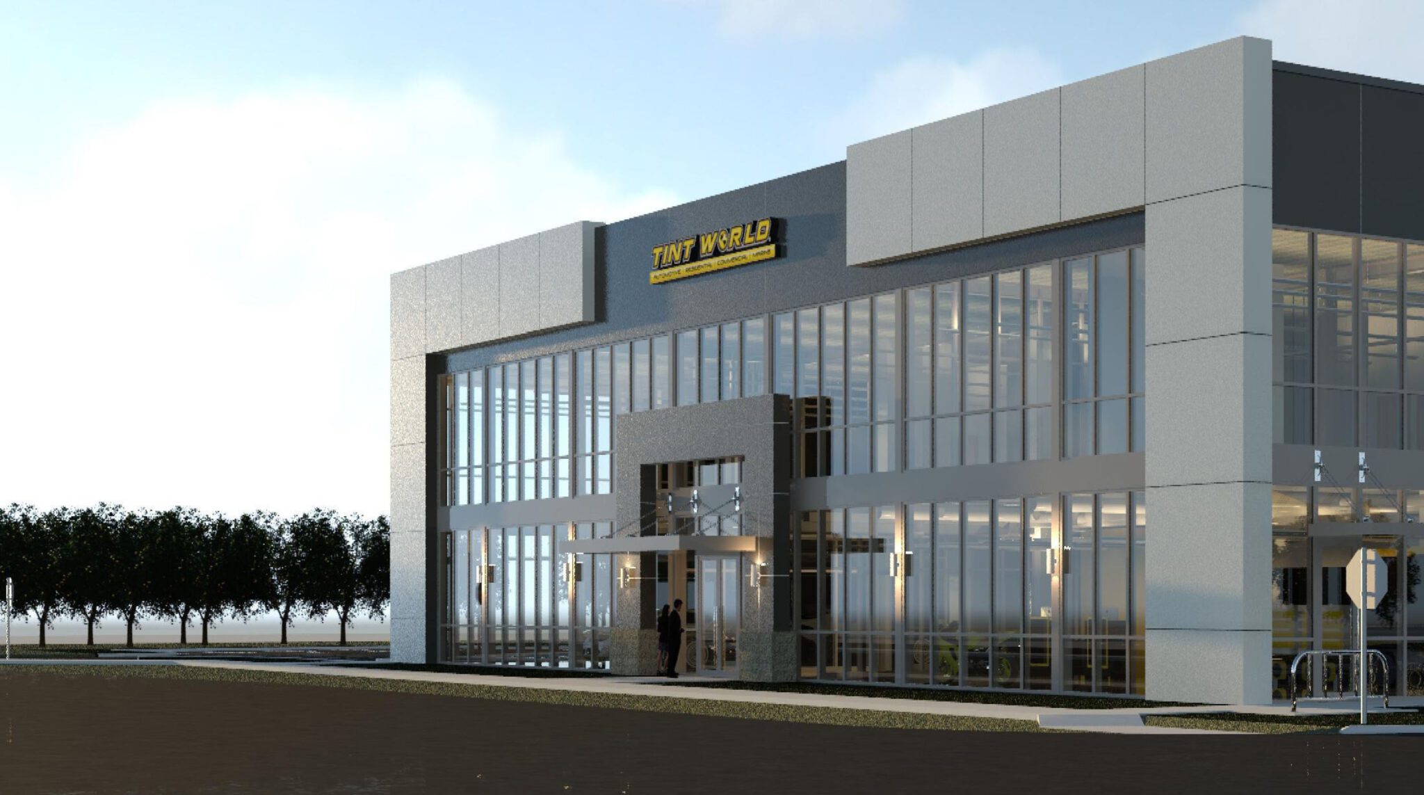 A modern two-story building with large glass windows and a sign reading "TNT World" on the front, reminiscent of an automotive styling center, is surrounded by a few trees and set against a clear Florida sky.