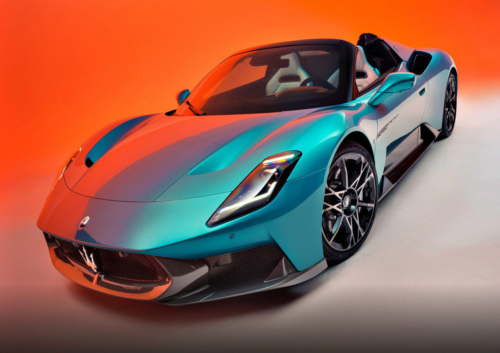 Turquoise Maserati MC20 Cielo convertible sports car with Liquid Crystal Roof on display against an orange gradient background.