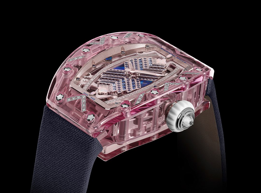 This Richard Mille RM 07-02 wristwatch from the Sapphire Collection boasts a pink skeleton design with a clear case and visible gears, complemented by a black strap and silver crown, set against a sleek black background.