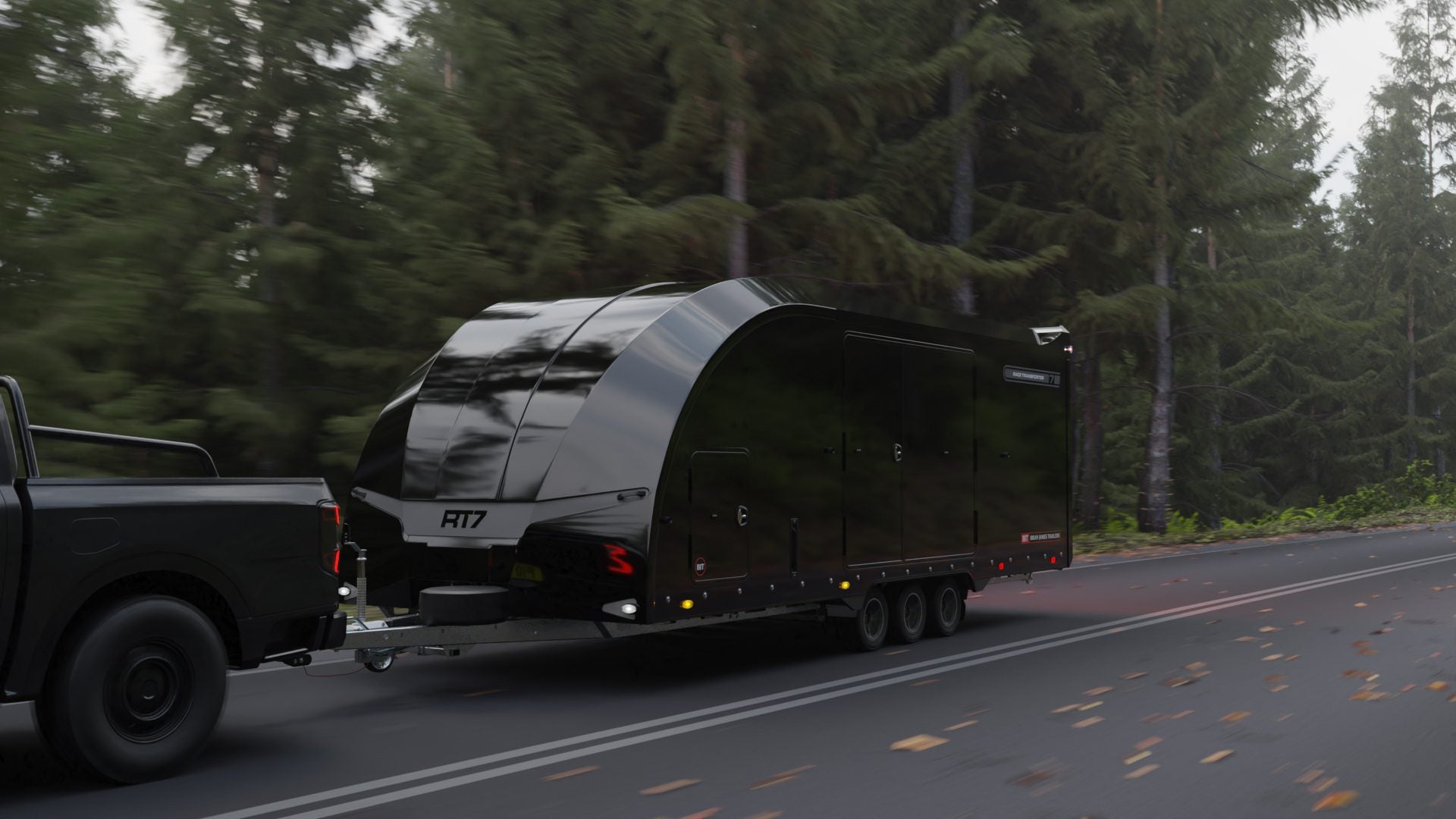 A black Race Transporter 7 enclosed car hauler labeled "RT17" is being towed by a dark pickup truck on a forested road, showcasing the quality of Brian James Trailers.