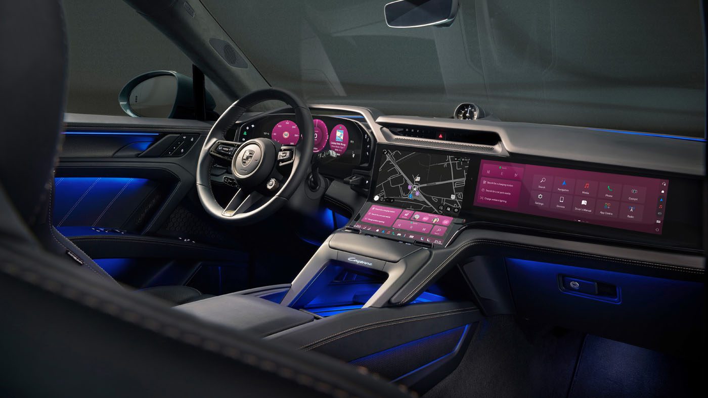 Modern car interior featuring digital instrument cluster, large touchscreen display with navigation, and ambient blue lighting.