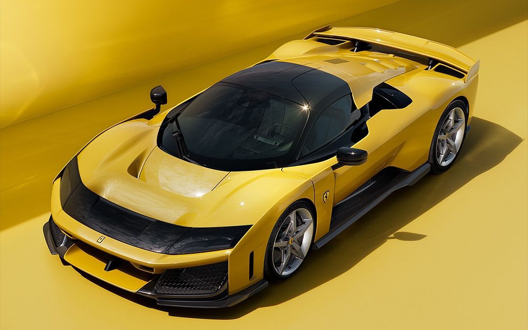 A sleek yellow sports car from the renowned Italian automaker, Ferrari, with black accents is parked against a matching yellow background. The design features aerodynamic curves and a prominent rear spoiler, epitomizing the luxury sports cars' aesthetic.