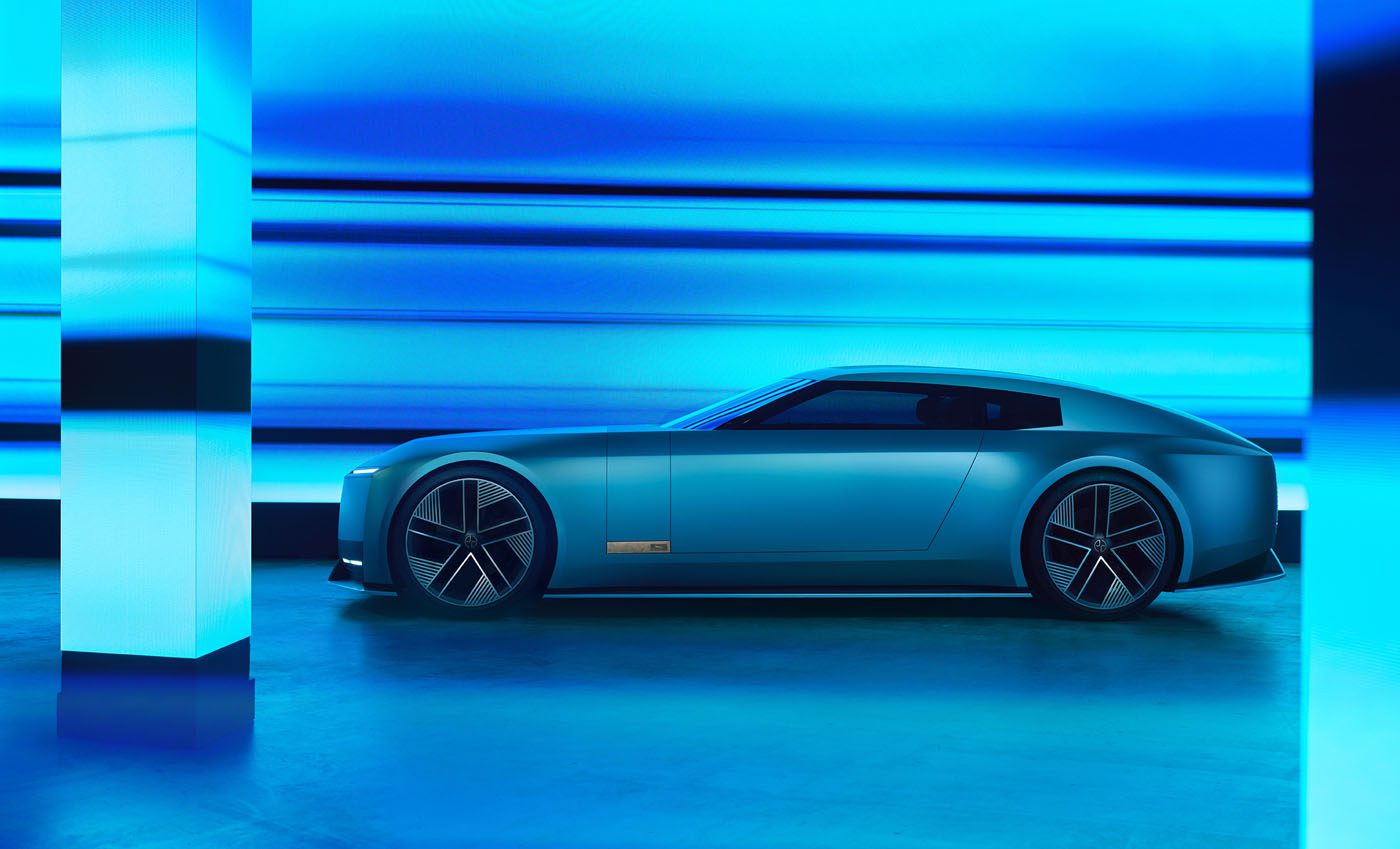 A sleek, modern Jaguar electric car, inspired by the Type 00 Concept, is parked indoors, illuminated by blue lighting and reflective surfaces like a Tokyo Art Installation.