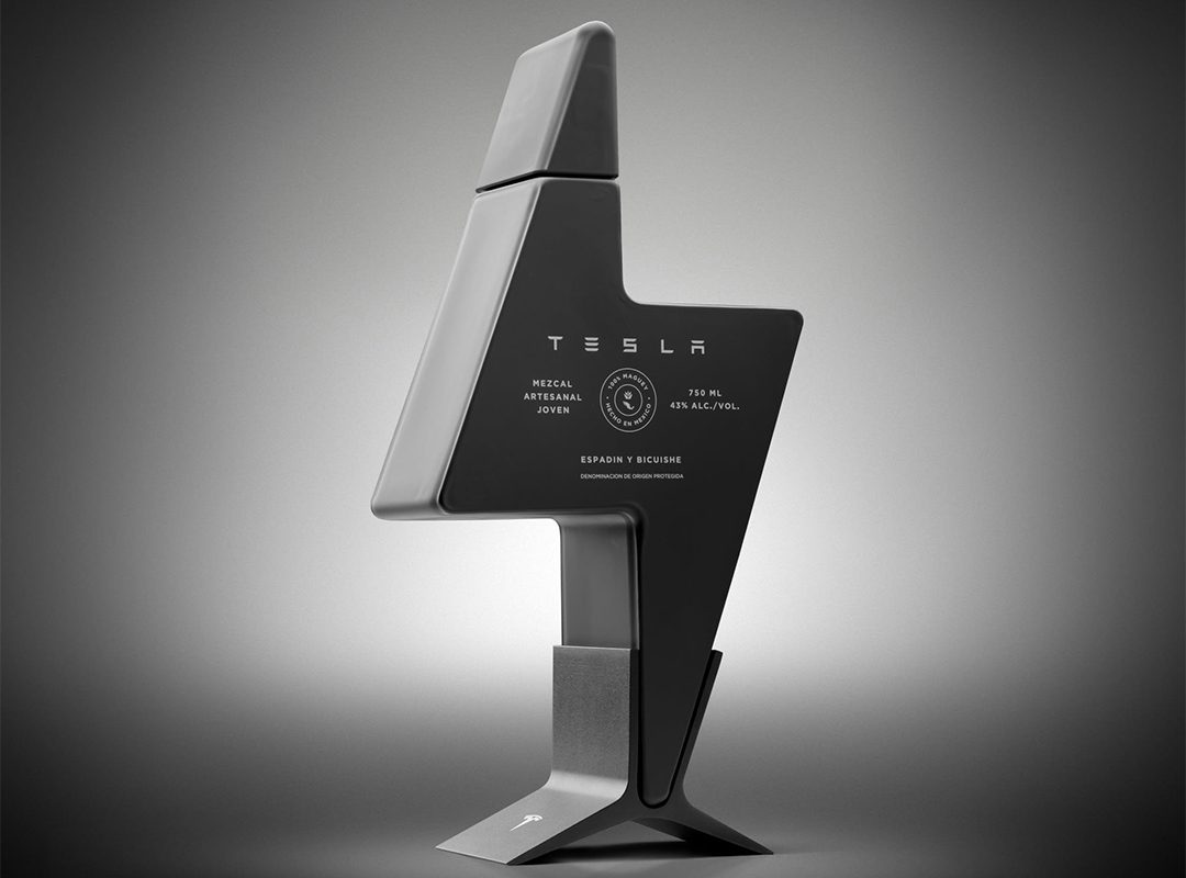The futuristic, lightning bolt-shaped bottle boasts a "Tesla" branding and mezcal label. Its matte gray finish and minimalist design exude exclusivity, making it a limited edition piece that stands proudly on an equally angular base.