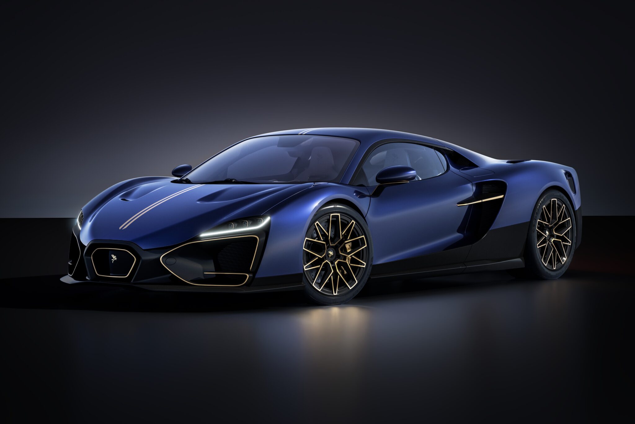 A sleek blue sports car with gold accents, low profile, aerodynamic curves, and large alloy wheels, inspired by Vittori’s new hybrid hypercar with Pininfarina design, is shown in a dimly lit studio setting.