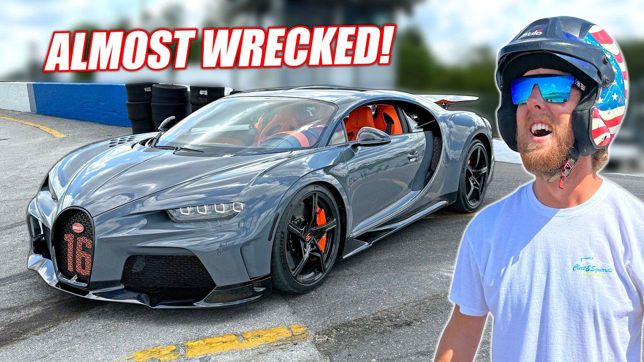 A man in a helmet stands near a gray Bugatti sports car at Freedom Factory racetrack with the text "ALMOST WRECKED!" above the car.
