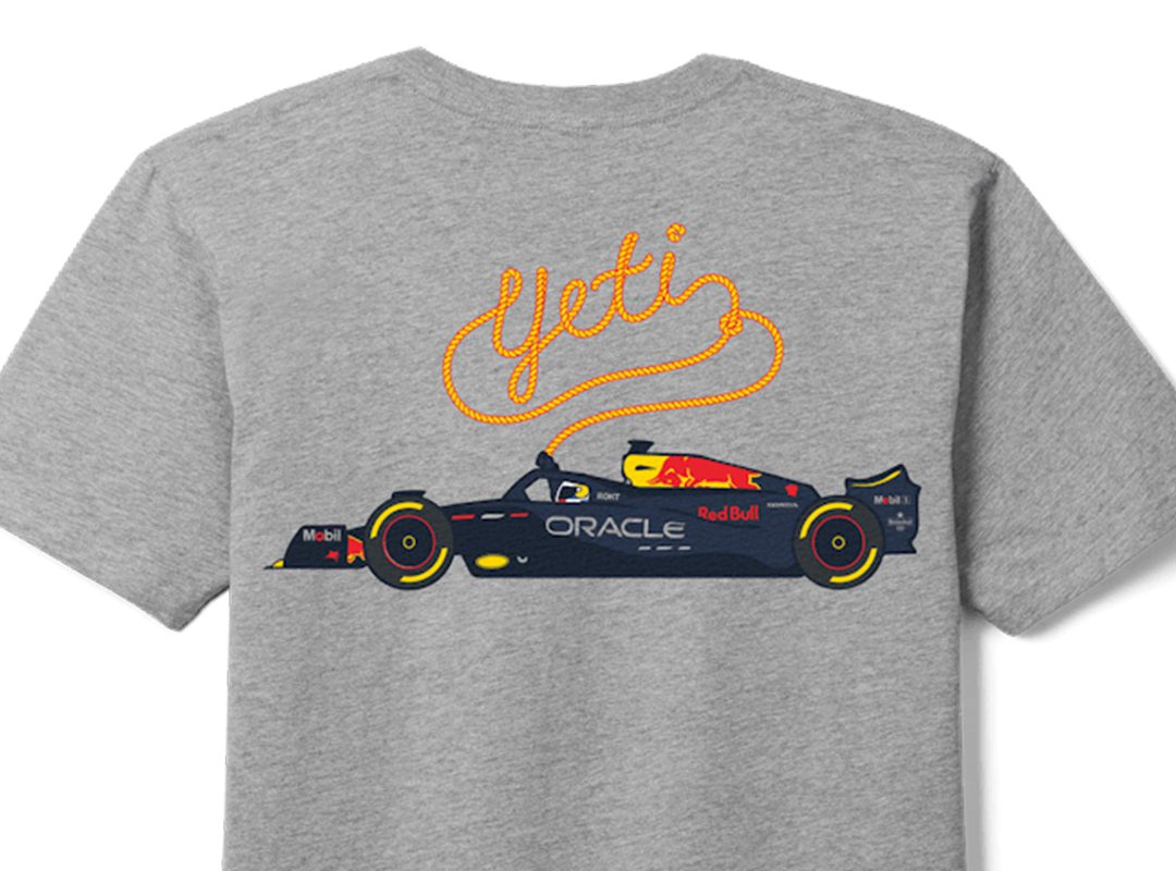 A grey t-shirt from the F1 collection features an illustration of an Oracle Red Bull Racing car with "YETI" written above in orange, rope-like script.