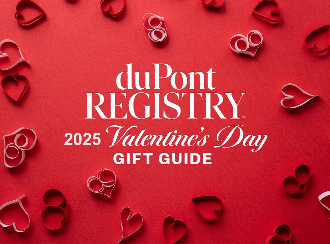 On a red background, white text announces "duPont REGISTRY 2025 Valentine's Day Gift Guide," adorned with paper heart shapes.