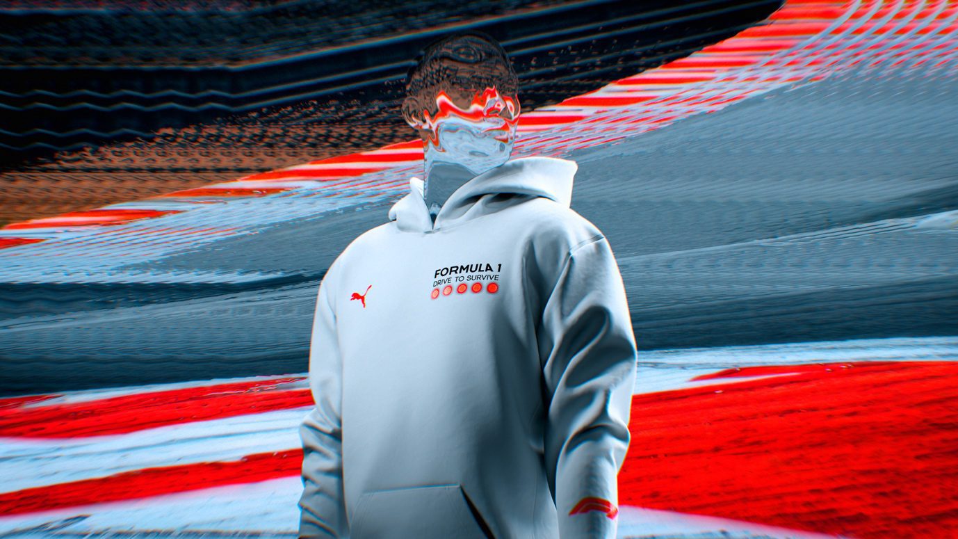 A person dons a Formula 1 logo hoodie from the Drive to Survive Collection, their face artfully distorted against a backdrop of blurred red and white streaks.