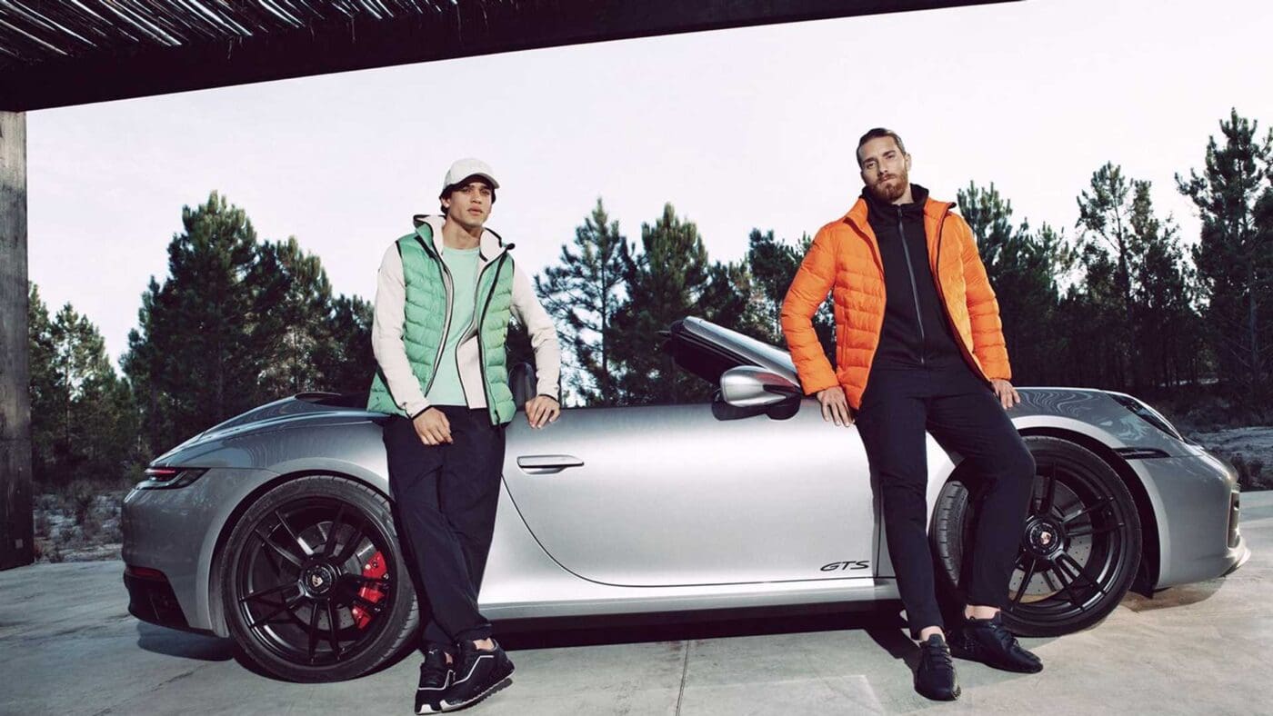 man infront porsche 911gts sportswear orange jacket green vest sneakers.jpg