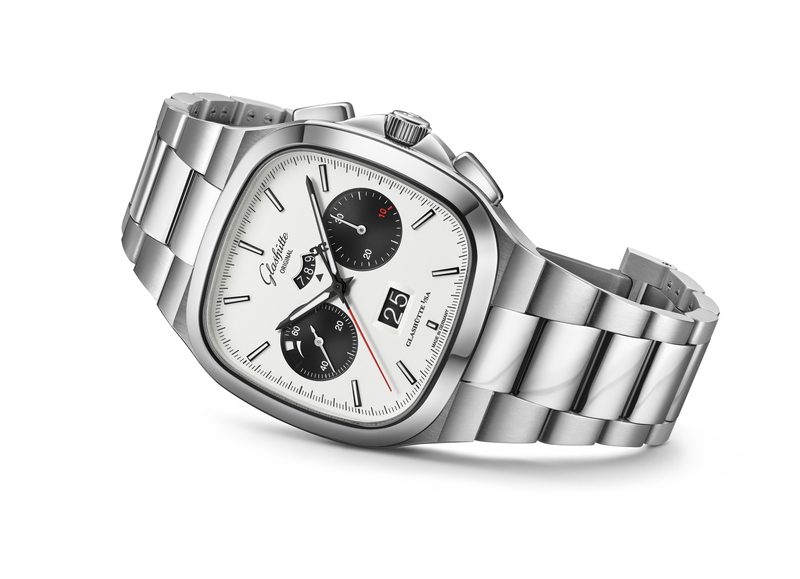 A North American-exclusive Glashütte Original Seventies X Chronograph, this stainless steel wristwatch features a white face, two black subdials, date display, and a metal link bracelet, shown at an angle.