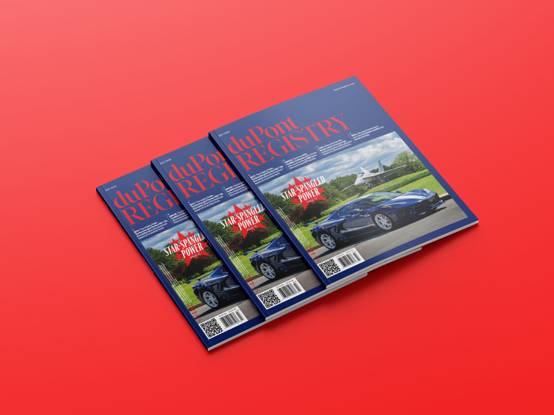 Three issues of duPont REGISTRY magazine, featuring a car on the cover, are stacked on a solid red surface.