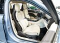 Interior view of the Lincoln Continental Coach Door Edition, showcasing beige leather seats, a sleek center console, and a stylish steering wheel.