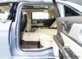 Experience the luxurious Lincoln Continental Coach Door Edition interior, featuring light-colored leather seats and advanced control panels. Viewed from the rear passenger door, this model offers ample legroom for ultimate comfort. Available now, for sale to discerning drivers seeking elegance.