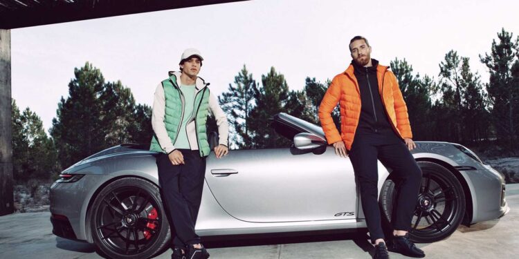 man infront porsche 911gts sportswear orange jacket green vest sneakers.jpg