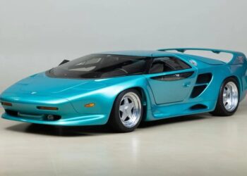 For sale: A 1993 teal sports car that exudes elegance with its sleek design, large rear spoiler, and prominent air intakes. This Vector Avtech WX-3 model is a rare find for enthusiasts seeking both style and performance.